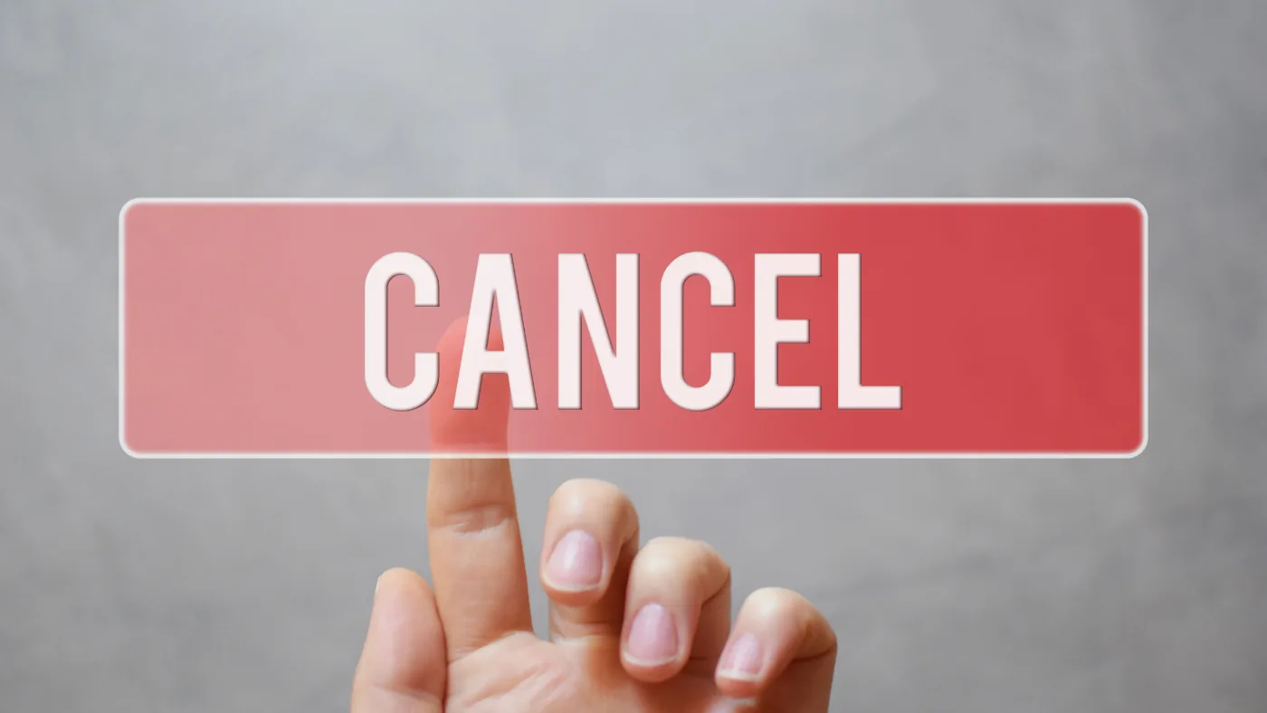 画面に表示された「CANCEL」のボタンを指で押そうとしているところ